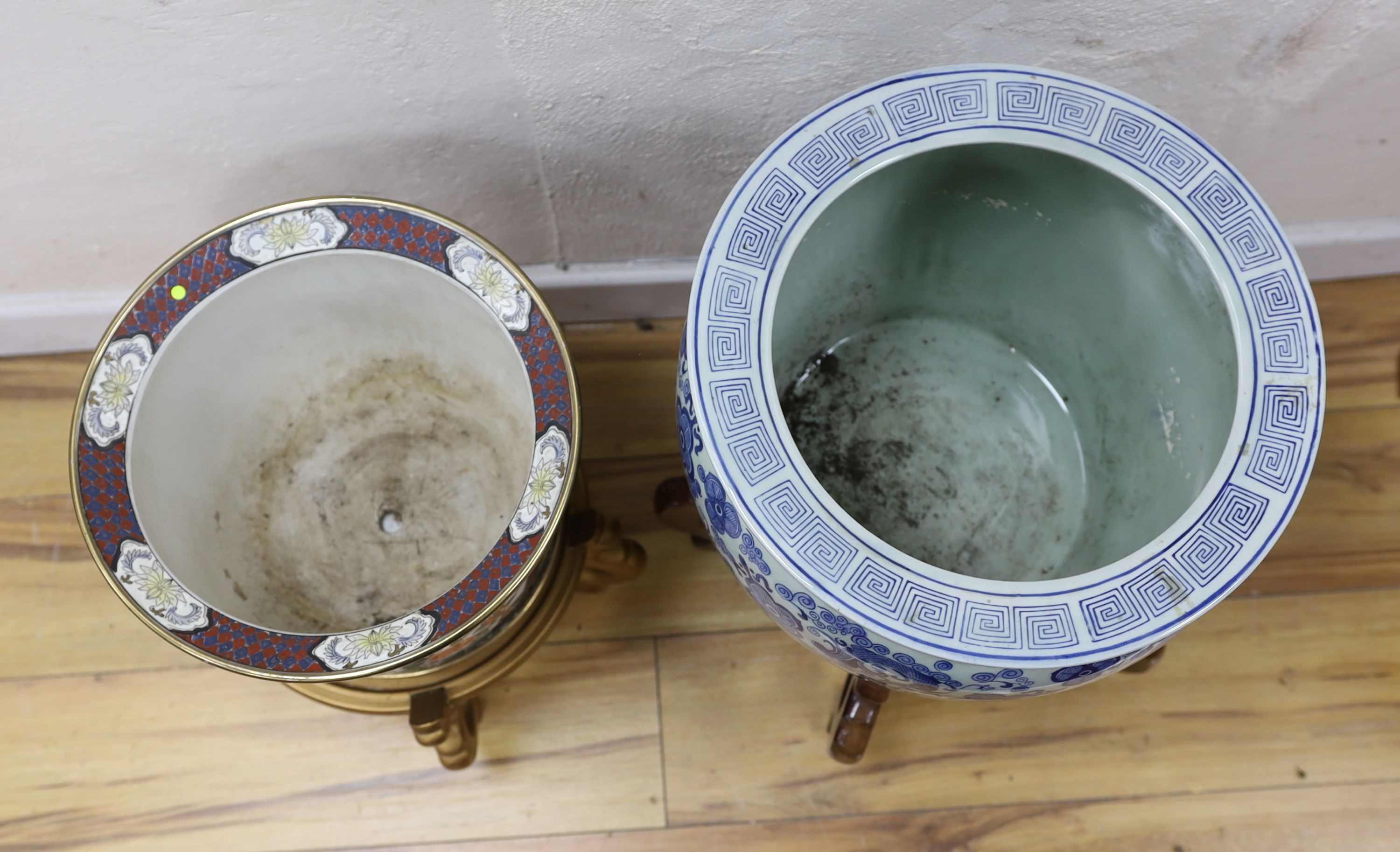 Two Chinese fish bowls on stands, tallest 51 cms including stand.